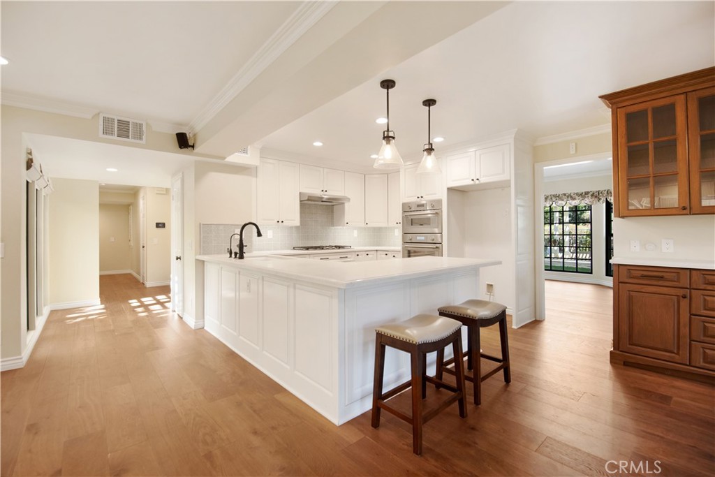 24965 Danamaple Dana Point, CA 92629 - Photo 15 of 72 a large white kitchen with lots of counter space and breakfast area