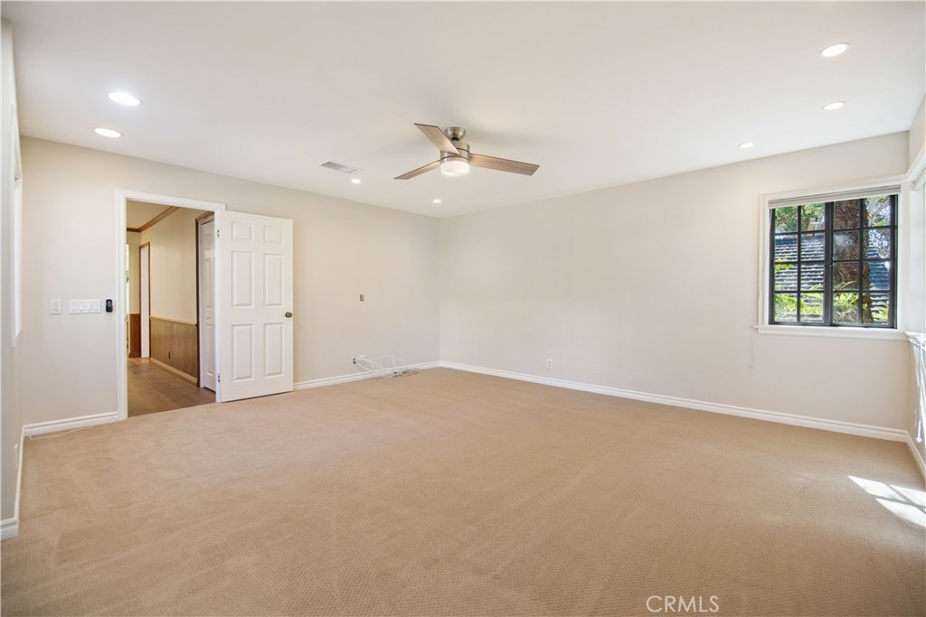 24965 Danamaple Dana Point, CA 92629 - Photo 33 of 72 an empty room with chandelier fan and windows