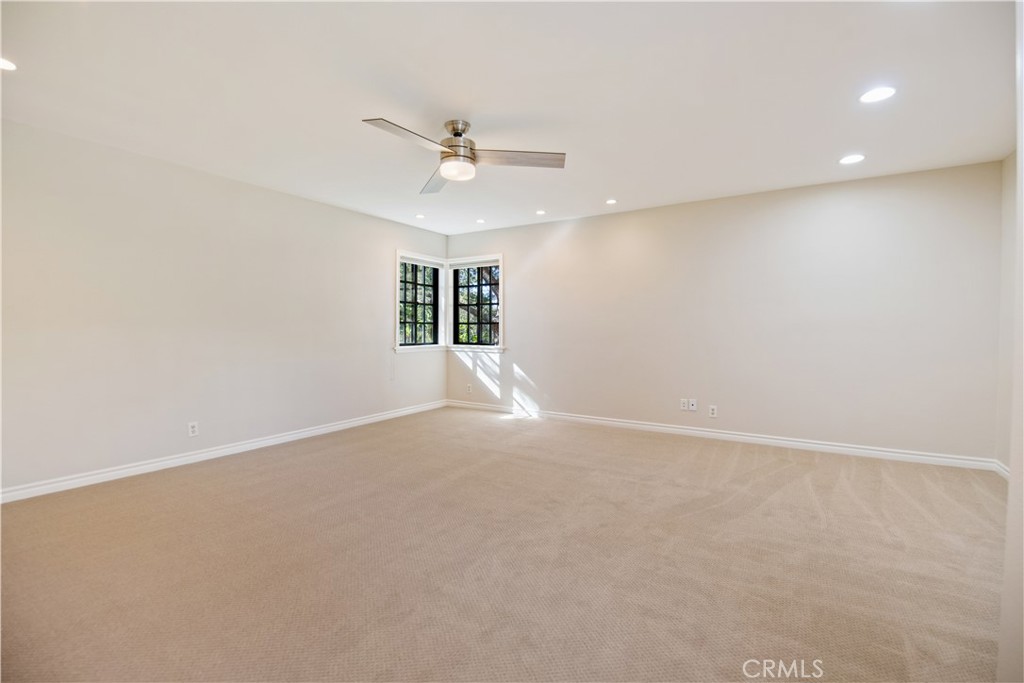 24965 Danamaple Dana Point, CA 92629 - Photo 34 of 72 en empty room with windows and ceiling fan view