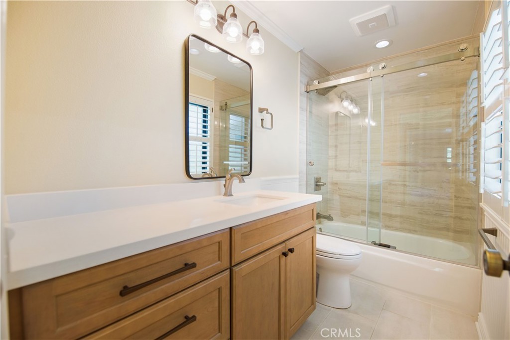 24965 Danamaple Dana Point, CA 92629 - Photo 36 of 72 a bathroom with a granite countertop sink a toilet a mirror and bathtub
