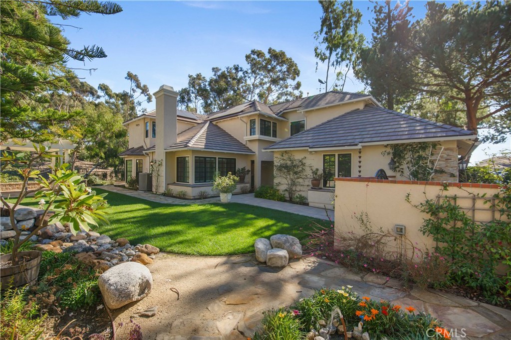24965 Danamaple Dana Point, CA 92629 - Photo 55 of 72 a front view of a house with a garden