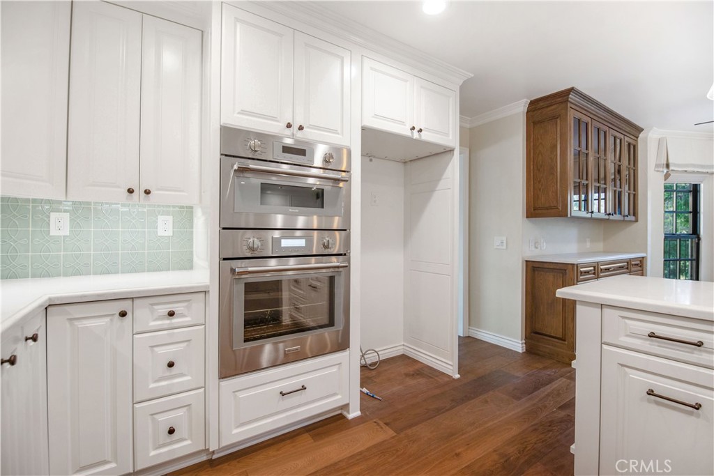 24965 Danamaple Dana Point, CA 92629 - Photo 7 of 72 a kitchen with cabinets stainless steel appliances and wooden floor