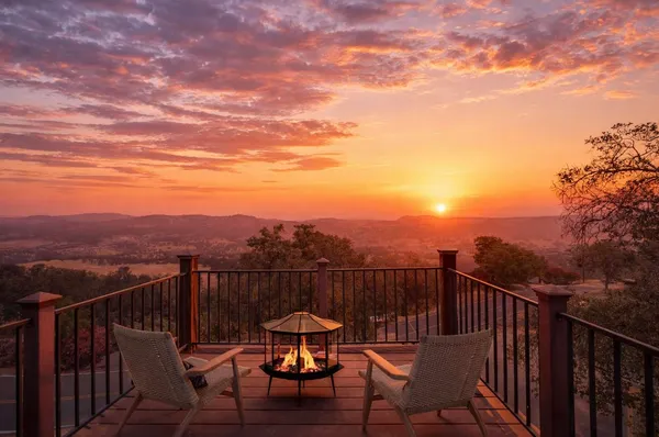 a view of a roof deck with chair and wooden floor