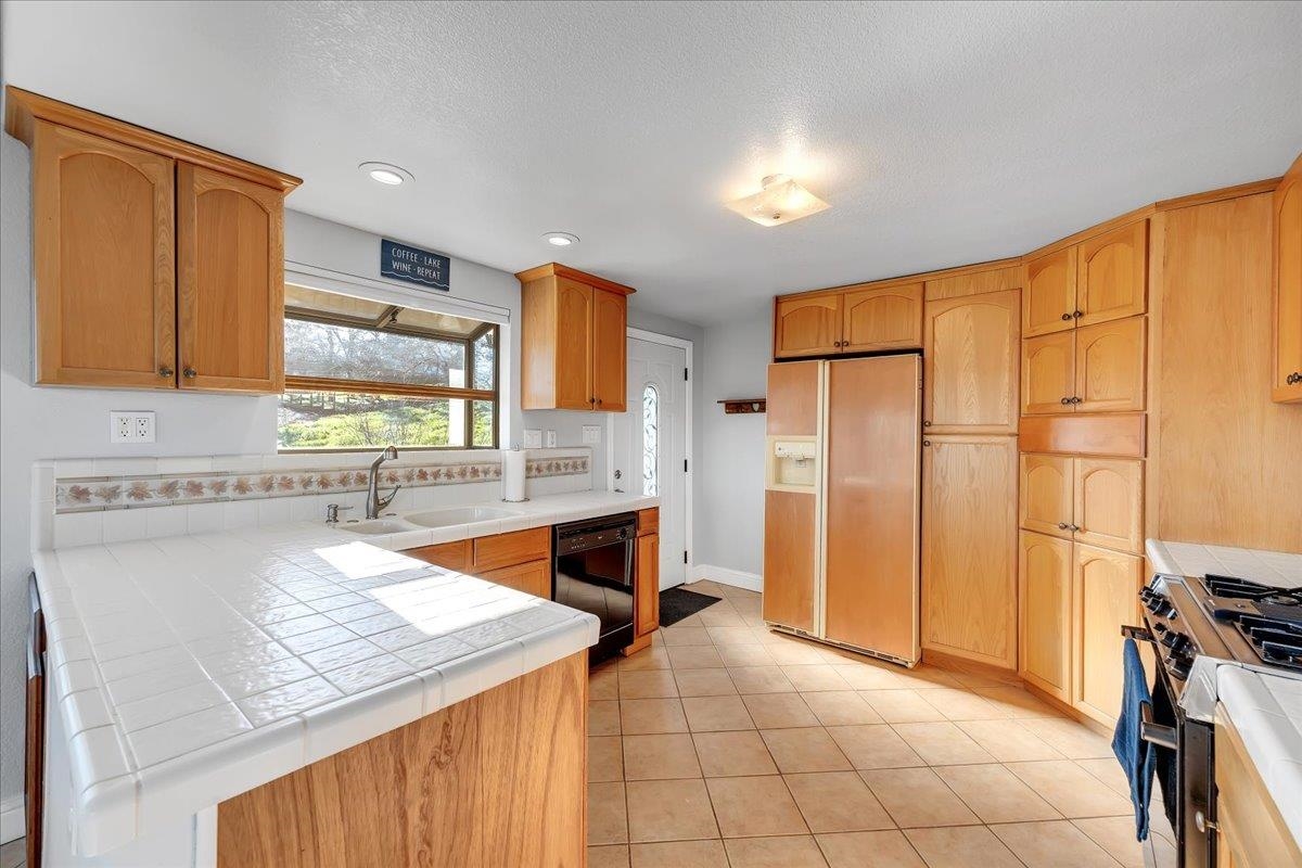 4620 Bayview Drive Copperopolis, CA 95228 - Photo 16 of 59 a kitchen with stainless steel appliances granite countertop a refrigerator and a stove top oven