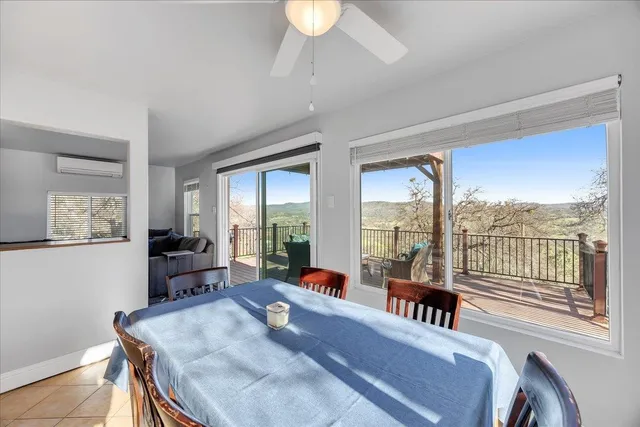 a living room with a large window and wooden floor
