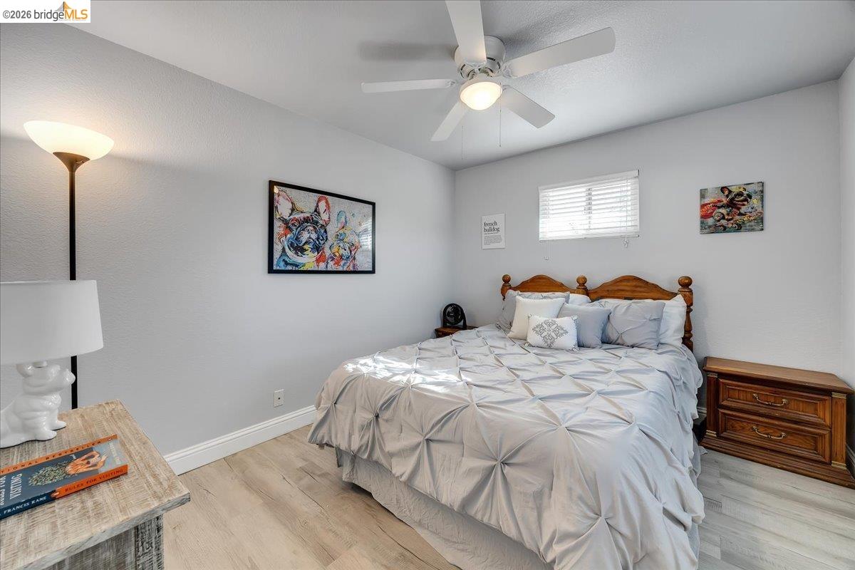4620 Bayview Drive Copperopolis, CA 95228 - Photo 26 of 59 a bedroom with a bed and a chandelier