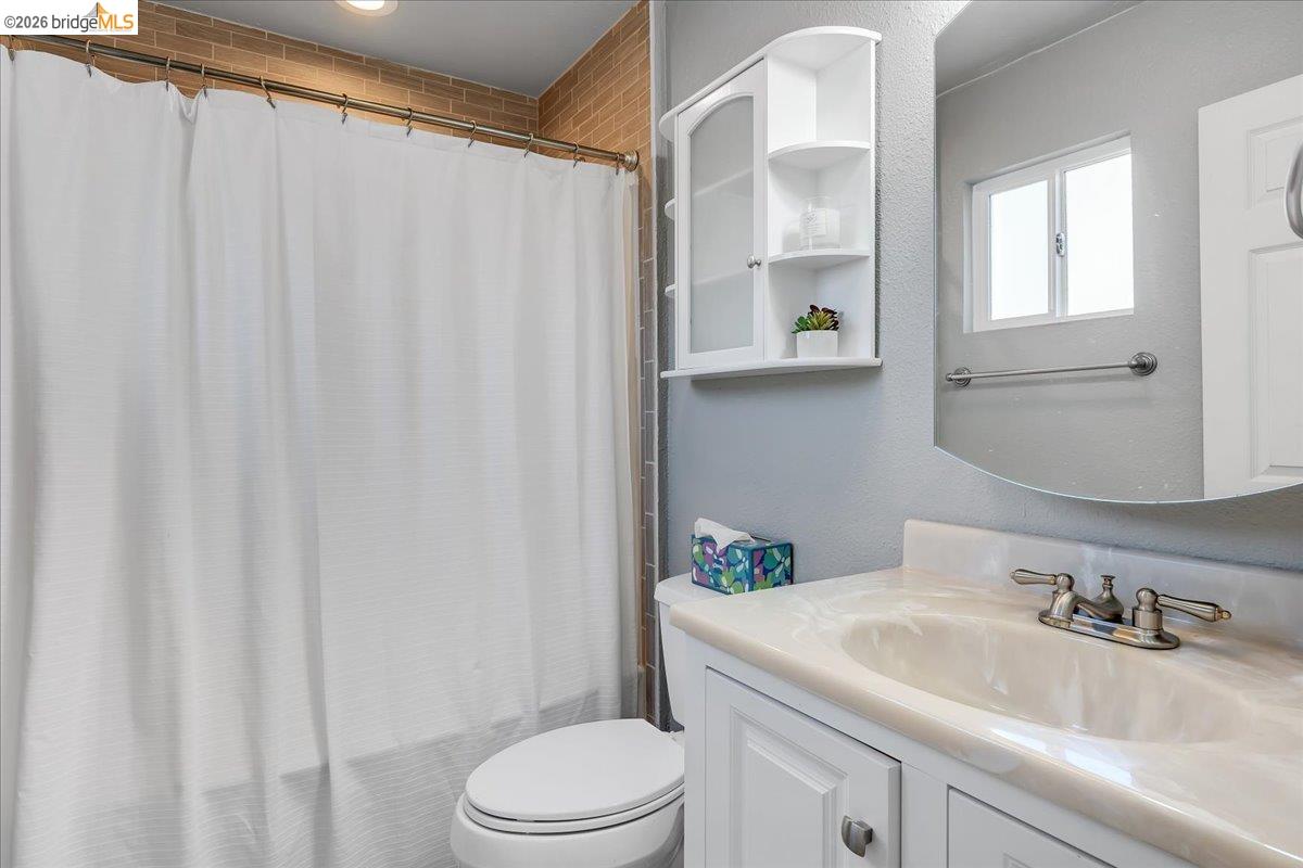 4620 Bayview Drive Copperopolis, CA 95228 - Photo 29 of 59 a bathroom with a sink a toilet and shower curtain