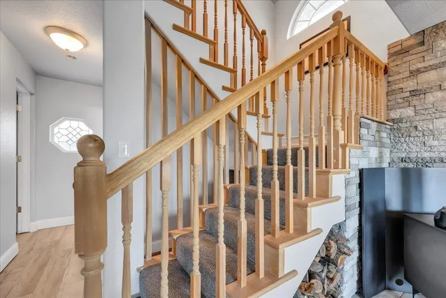 a bathroom with a granite countertop sink a mirror and shower