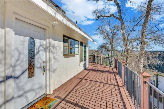 a view of a balcony with wooden floor and fence