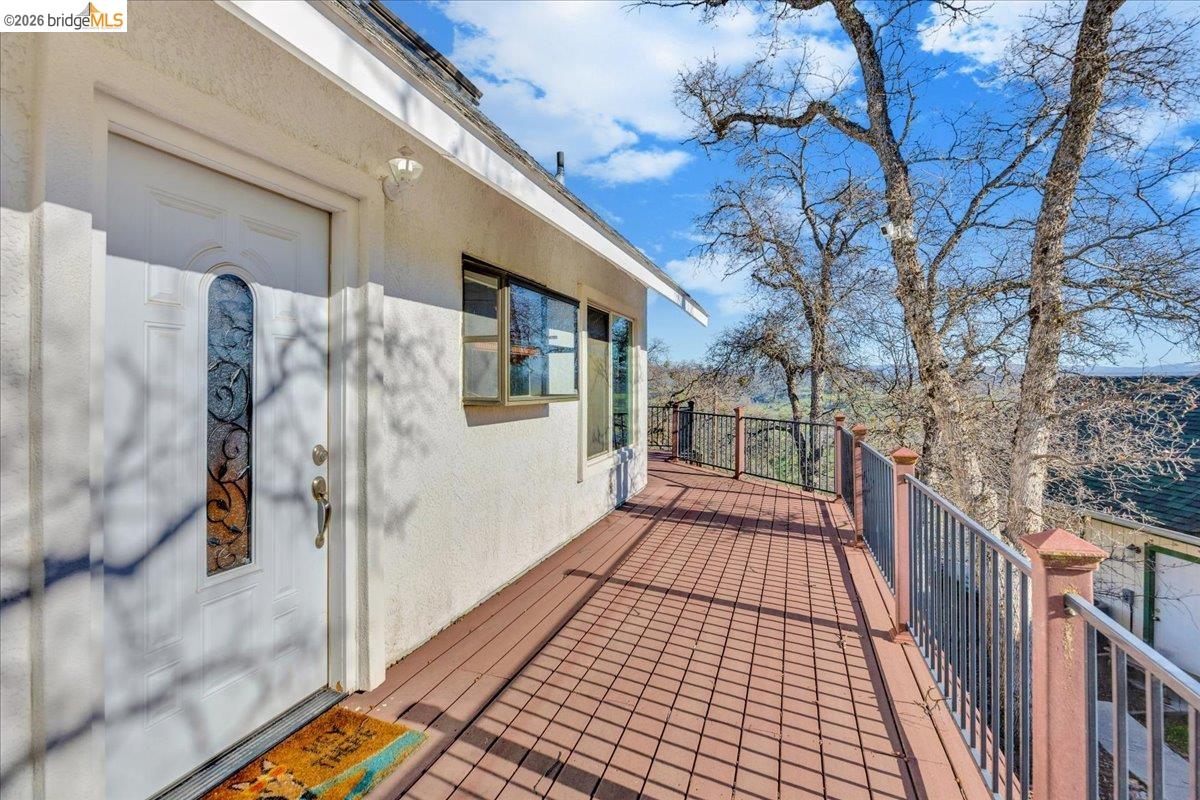 4620 Bayview Drive Copperopolis, CA 95228 - Photo 3 of 59 a view of a balcony with wooden floor and fence