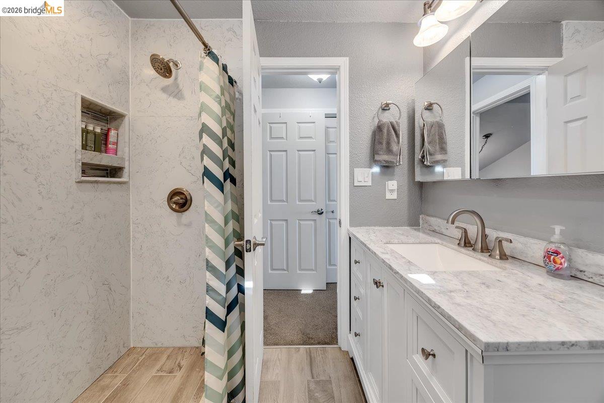 4620 Bayview Drive Copperopolis, CA 95228 - Photo 34 of 59 a bathroom with a granite countertop sink a mirror and shower