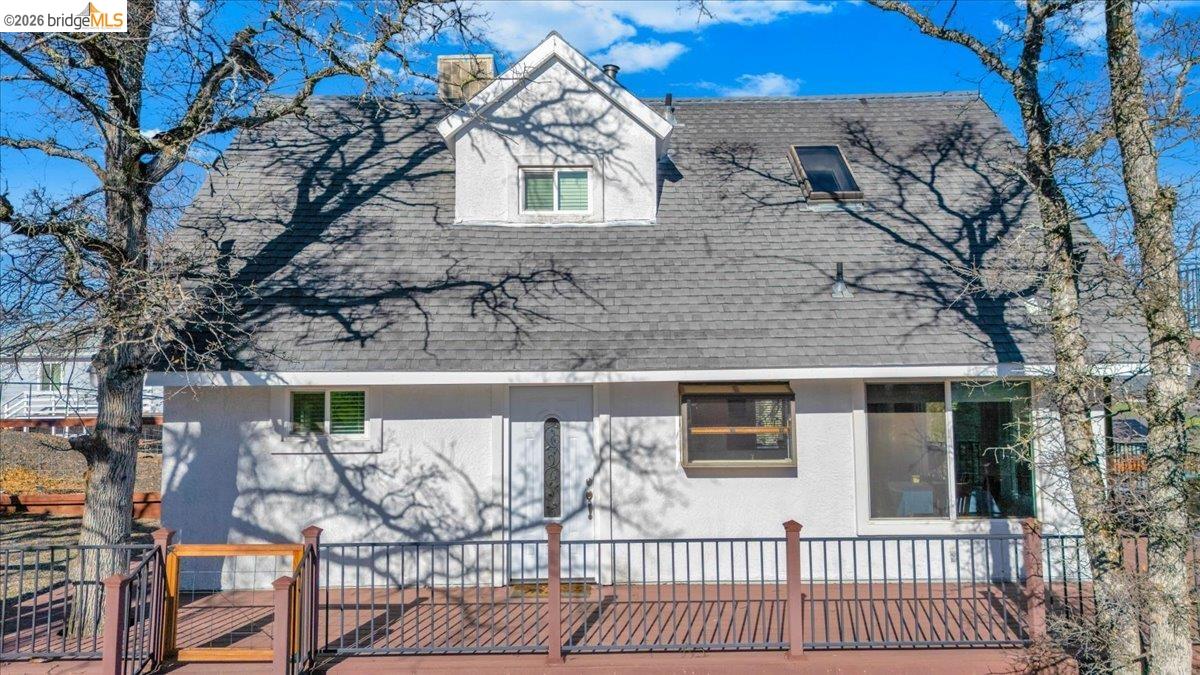4620 Bayview Drive Copperopolis, CA 95228 - Photo 8 of 59 View of front of home featuring a shingled roof, stucco siding, and a chimney