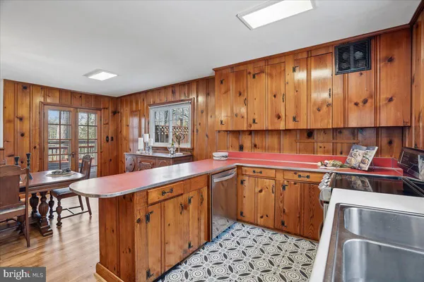 a bathroom with a granite countertop sink mirror and a bathtub