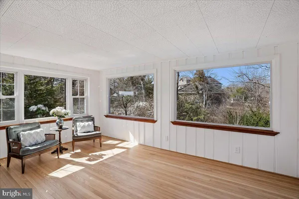 a bedroom with a bed and a lamp on the dresser