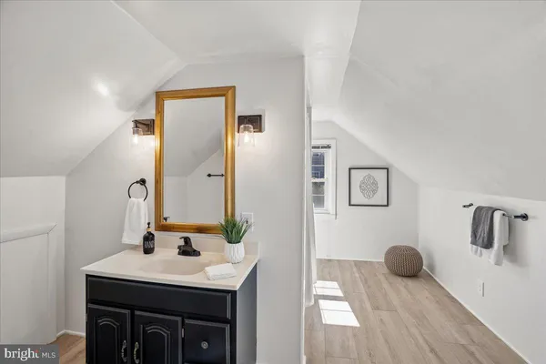 a picture of a bench in front of a wall