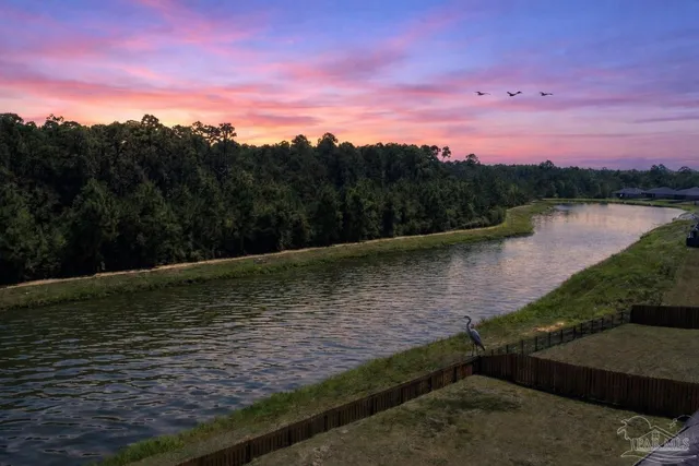 a view of kitchen with sink microwave and refrigerator