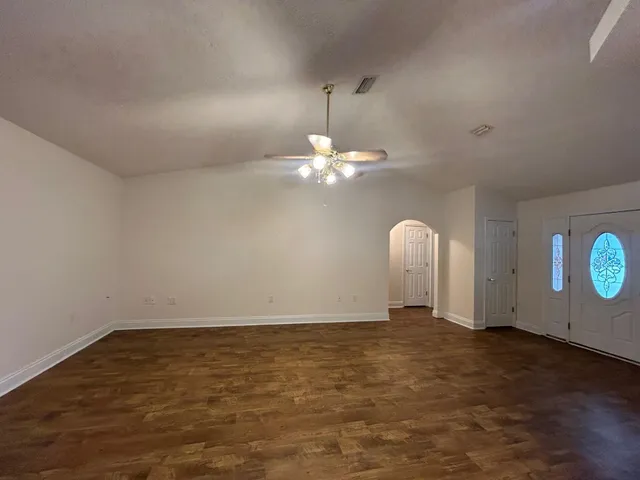 a view of a chandelier fan and hardwood floor