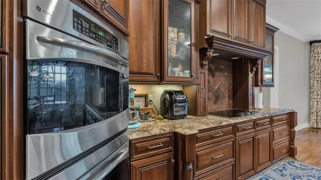 a dining room filled chandelier and wooden floor