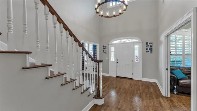 a view of entryway and hall with wooden floor