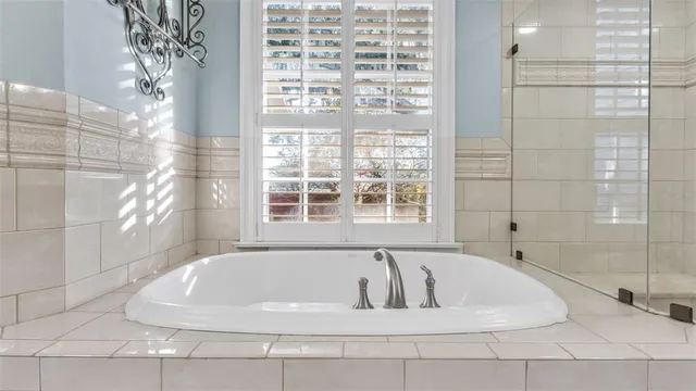 a en suite bathroom with a granite countertop sink and a mirror