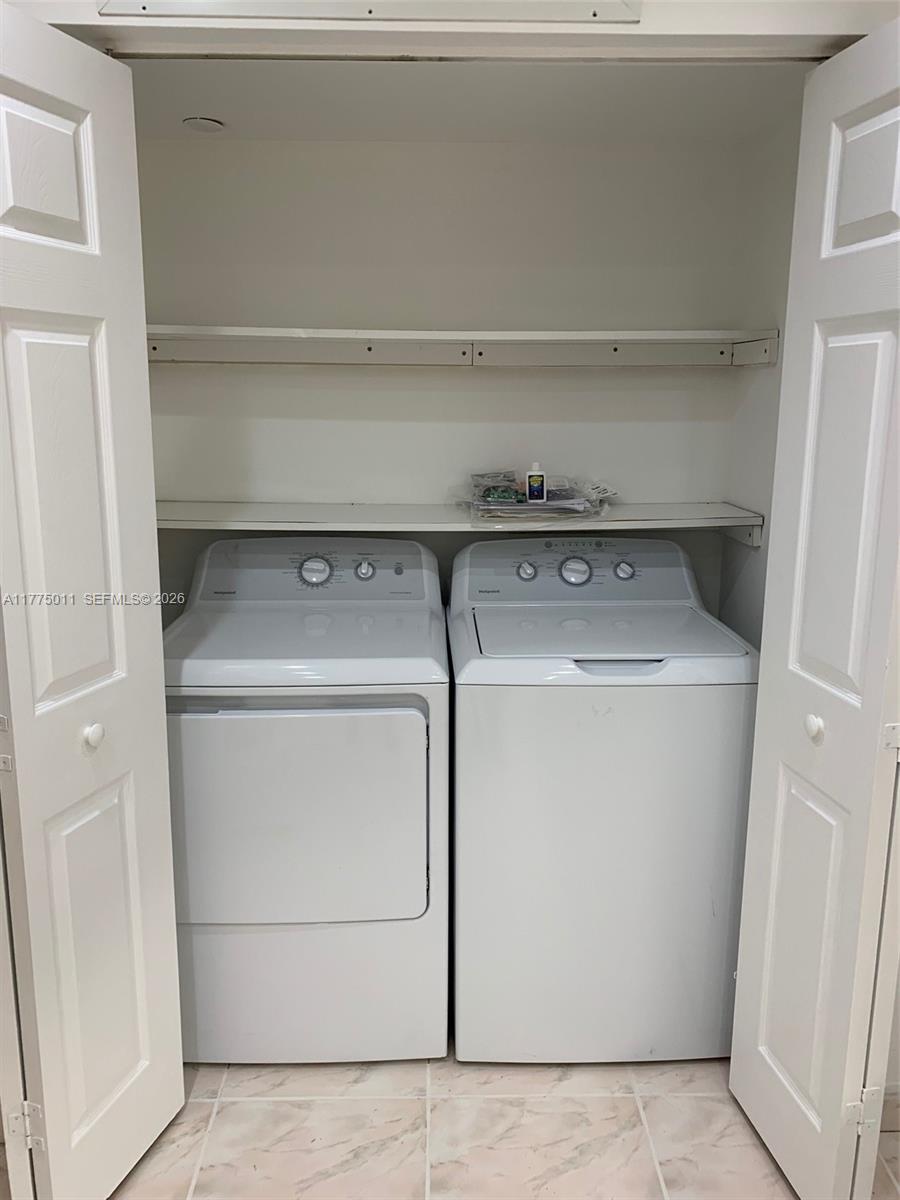 8855 Collins Avenue, Unit 5B Surfside, FL 33154 - Photo 12 of 35 a utility room with dryer and washer