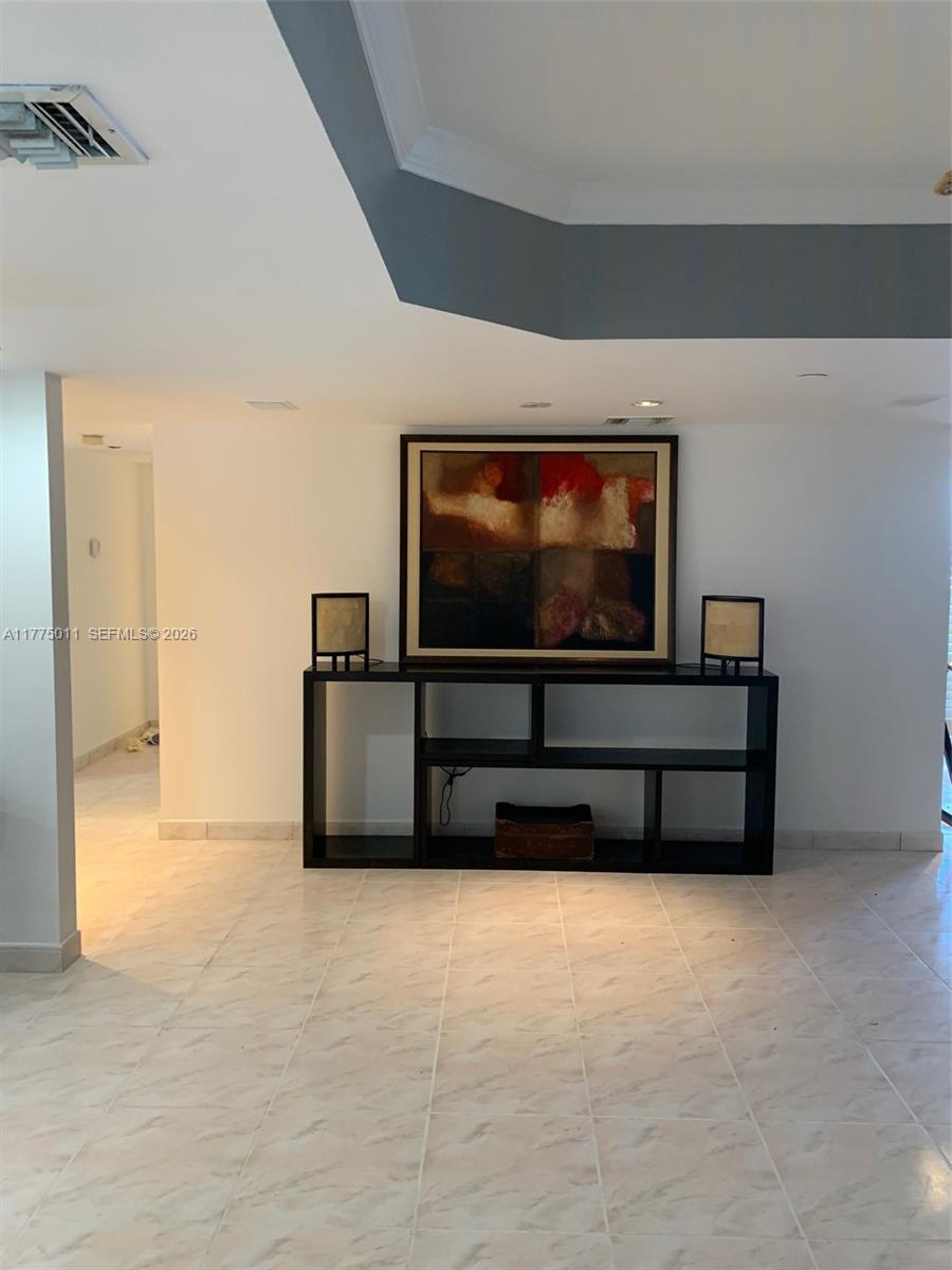 8855 Collins Avenue, Unit 5B Surfside, FL 33154 - Photo 13 of 35 a living room with furniture and a flat screen tv