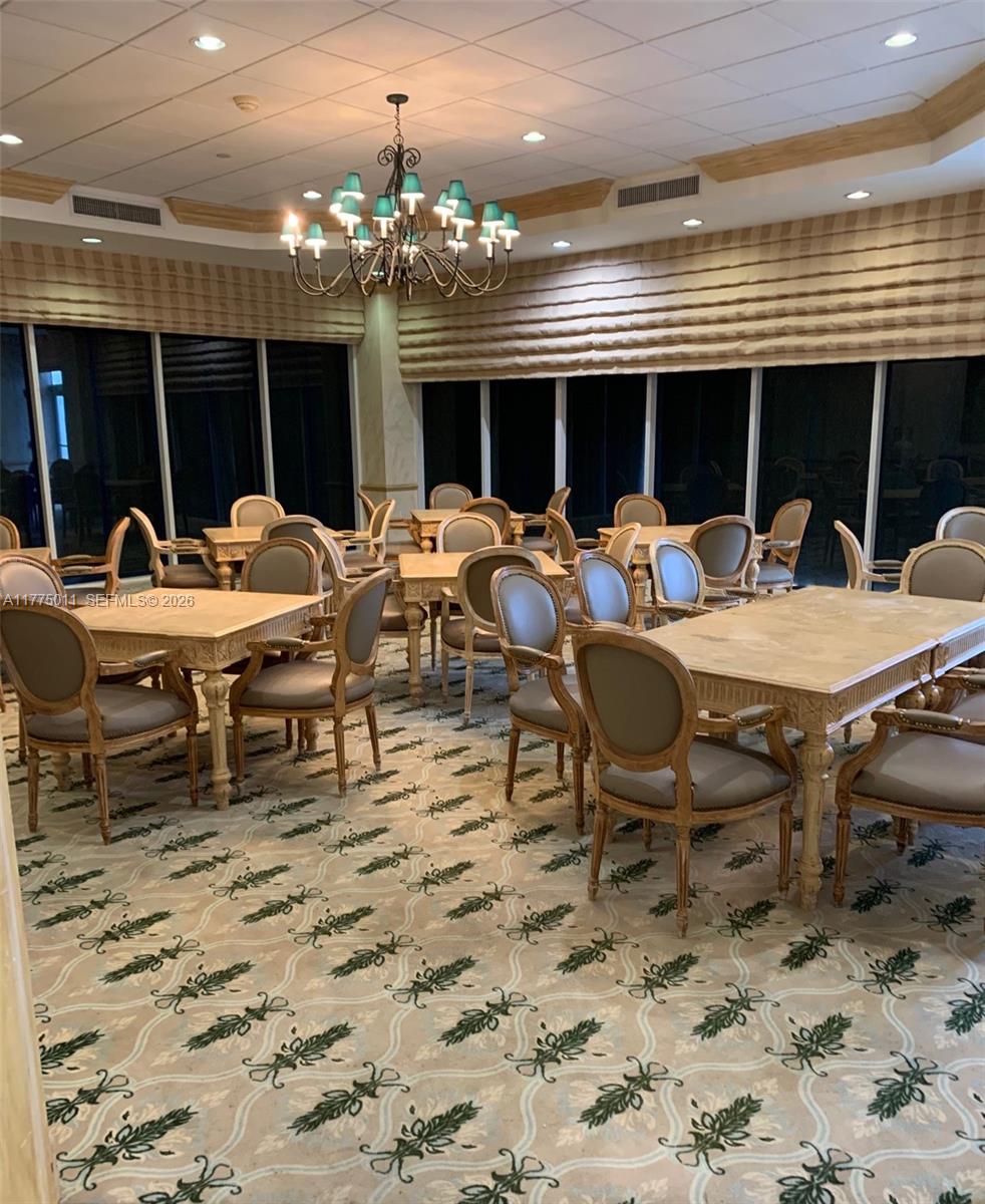 8855 Collins Avenue, Unit 5B Surfside, FL 33154 - Photo 4 of 35 a view of a dinning table and chairs in the patio