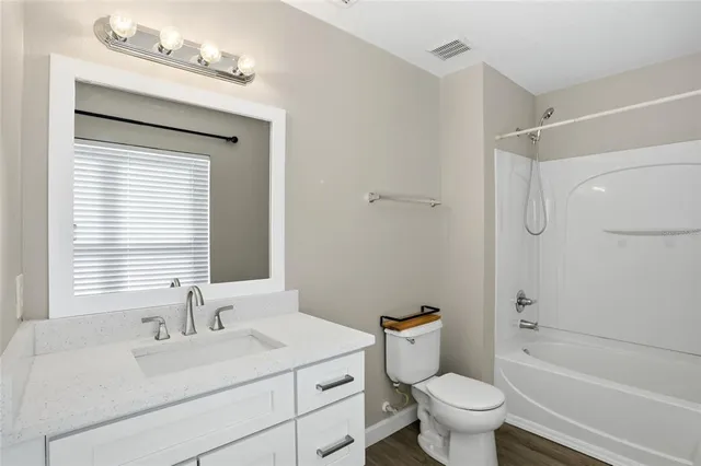 an aerial view of a house with yard