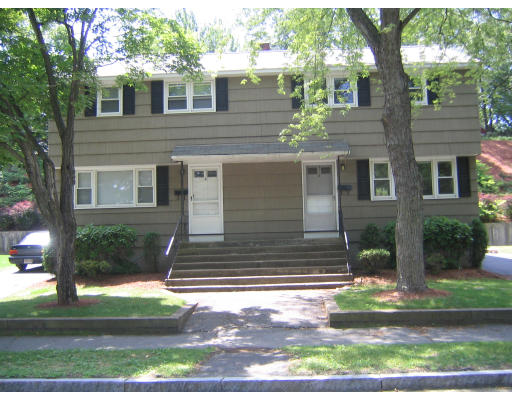 8 George Road Winchester, MA 01890 - Photo 1 of 9 a front view of a house with a yard