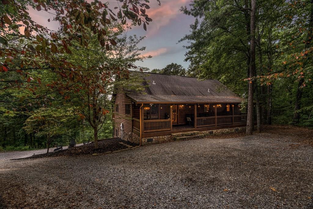 a view of a house with a yard and wooden fence