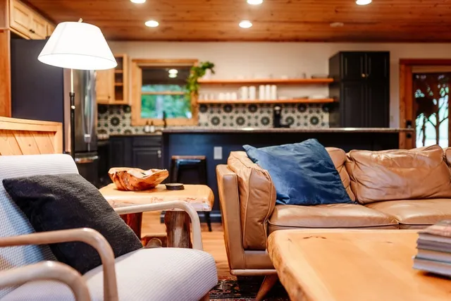 a living room with furniture a lamp and a large window