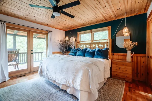 a bed sitting in a bedroom next to a window