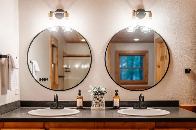 a bathroom with a double vanity sink and a mirror