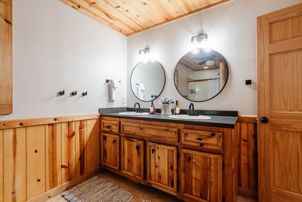 145 Daybreak Boulevard Morganton, GA 30560 - Photo 23 of 40 a bathroom with a double vanity sink and a mirror