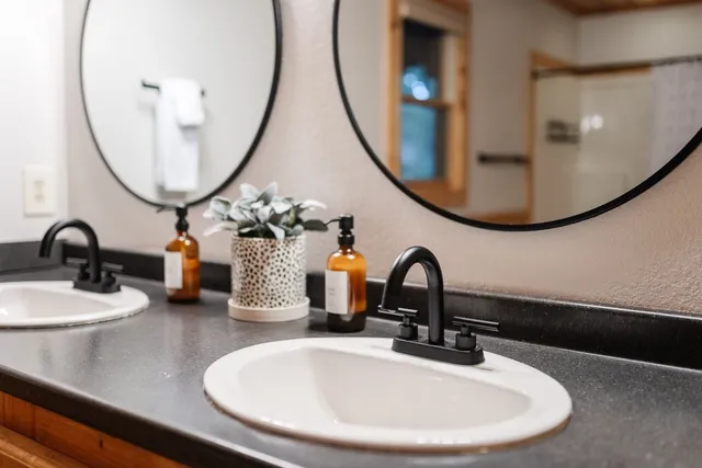 a bathroom with a tub sink and a window