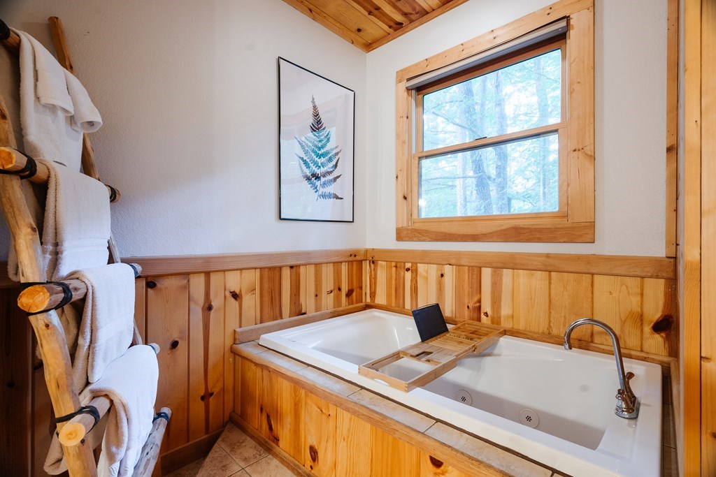 145 Daybreak Boulevard Morganton, GA 30560 - Photo 25 of 40 a bathroom with a tub sink and a window