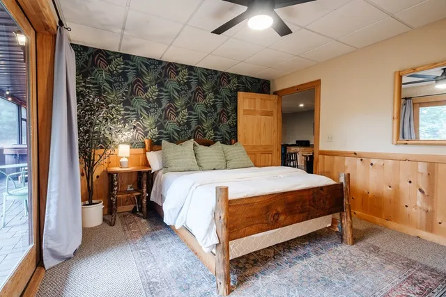 a bedroom with a large bed and a chandelier