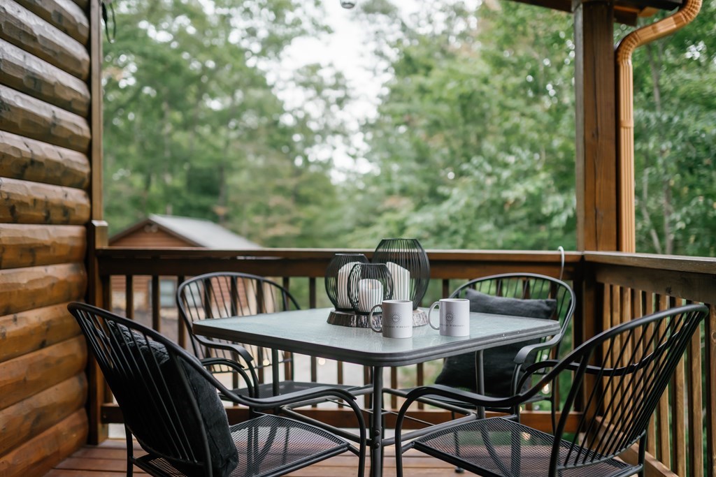 145 Daybreak Boulevard Morganton, GA 30560 - Photo 8 of 40 a view of a balcony with a wooden table and chairs