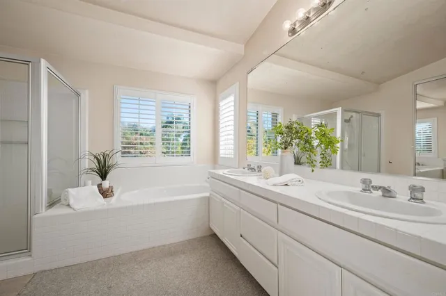 a bathroom with a bathtub a sink and a window