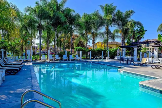 a swimming pool with outdoor seating and yard