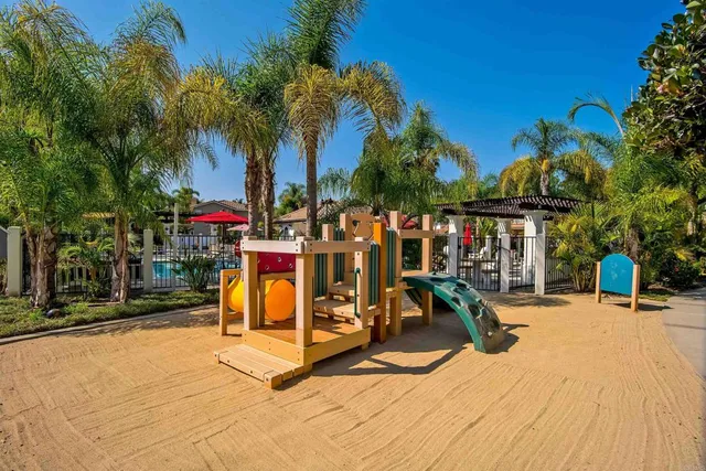 a view of a park with swings and slides