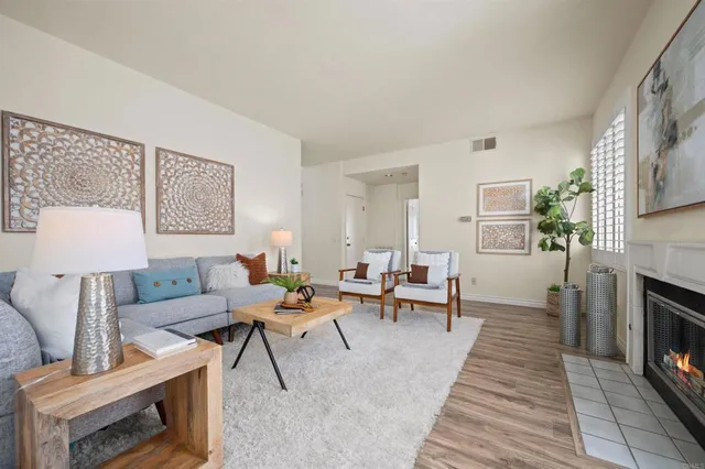 a living room with furniture and a fireplace