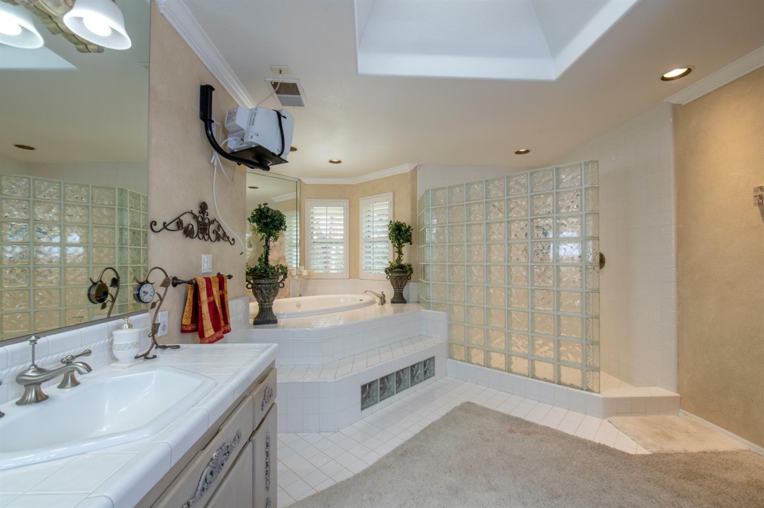 2873 Carolina Avenue Clovis, CA 93611 - Photo 17 of 23 a spacious bathroom with a double vanity sink mirror and shower