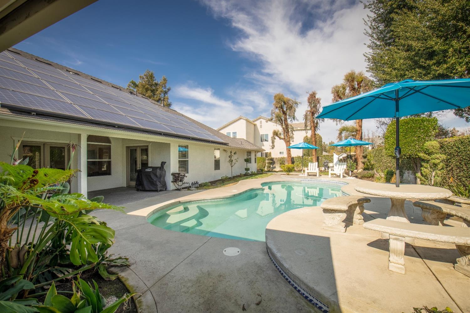 2873 Carolina Avenue Clovis, CA 93611 - Photo 3 of 23 a view of a house with swimming pool and sitting area