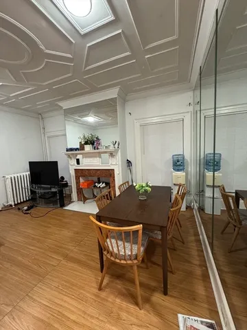 a dining room with furniture and wooden floor