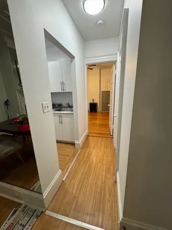 a view of a kitchen from a hallway