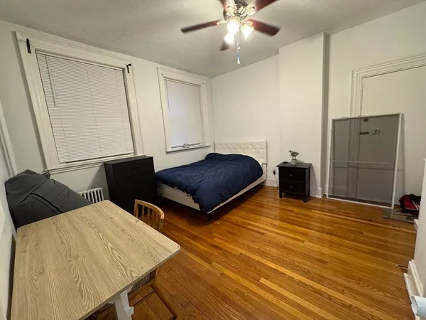 a living room with a bed and a walk in closet