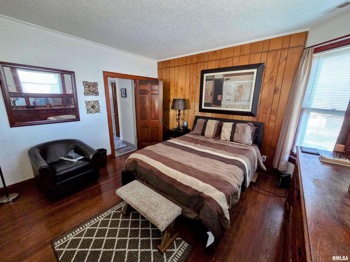 800 6th Avenue South Clinton, IA 52732 - Photo 7 of 12 a bedroom with a bed and a dresser next to a window