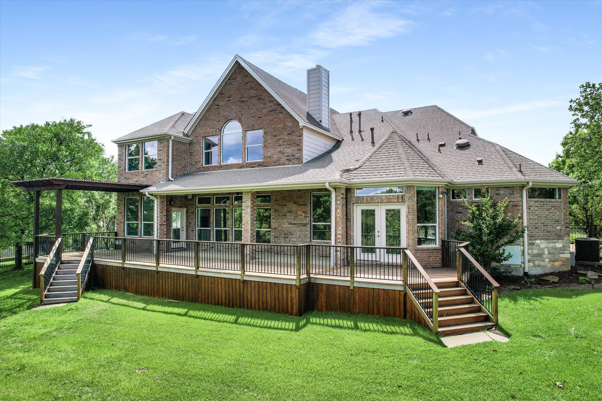 1400 Tom Sawyer Road Austin, TX 78737 - Photo 27 of 40 Expansive multi-level wood-finish deck with black metal railings