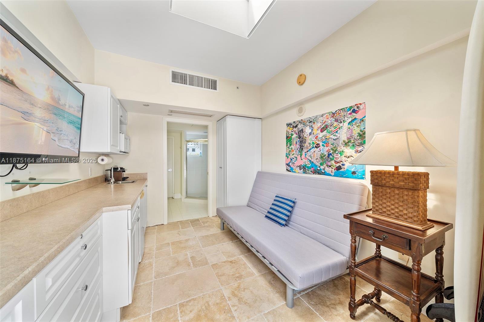 4775 Collins Avenue, Unit CAA14 Miami Beach, FL 33140 - Photo 3 of 4 a living room with furniture and a flat screen tv